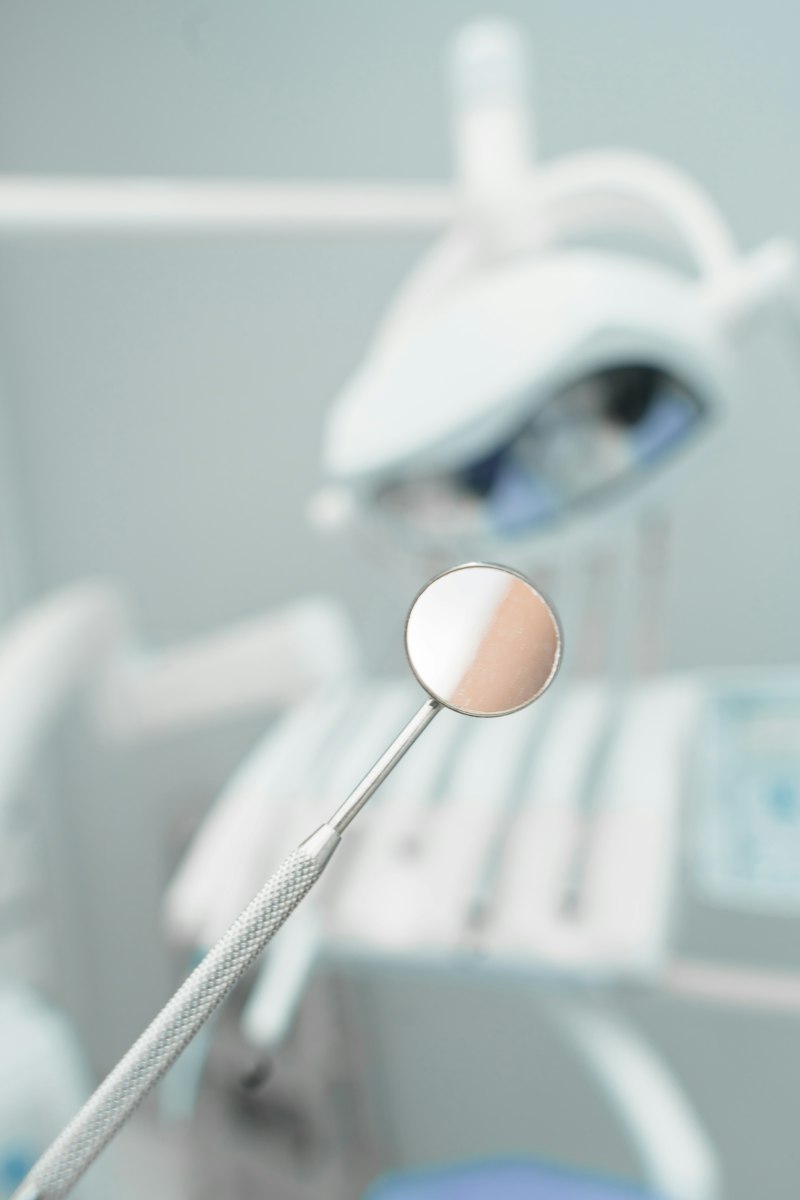 A dental mirror in a bright treatment room